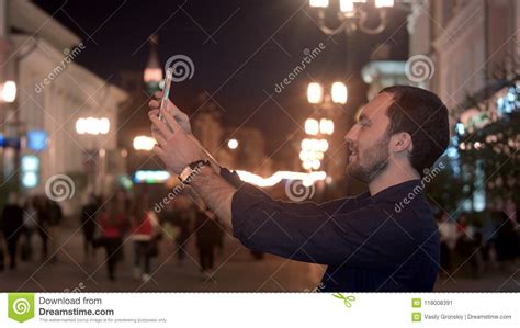 Tourist Man Taking Photo In With Smartphone At Night City Stock Image