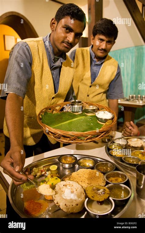 Two Waiters Serve A Traditional Gujarati Thali Meal Stock Photo Alamy