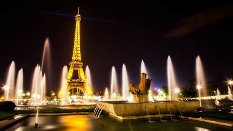 Eiffel Tower With Yellow Lights Around Water Fountain With Black Sky