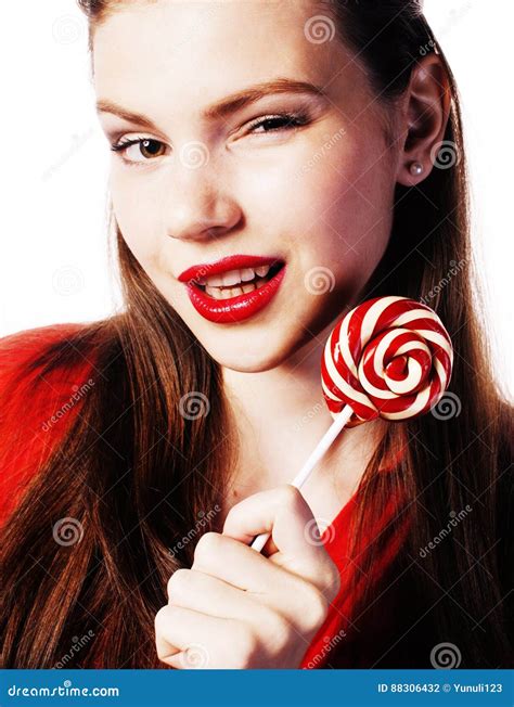 Young Pretty Brunette Girl With Red Candy Posing On White Backgr Stock