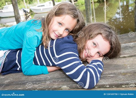 Two Girls Kids Sisters Loving Each Other Hugging And Kissing Stock