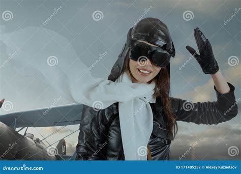 Portrait Of Lovely Brunette Girl In Retro Pilot Costume Giving Military Salute Stock Image