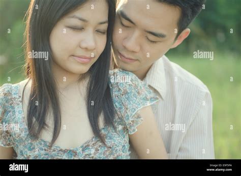 Chinese Young Couple Embracing Each Other On Meadow Stock Photo Alamy