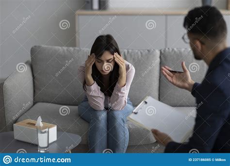 psychotherapy concept depressed arab woman touching head seeking professional help with mental