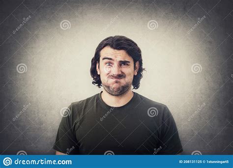 Portrait Of Bewildered And Annoyed Young Man Long Curly Hair Looking