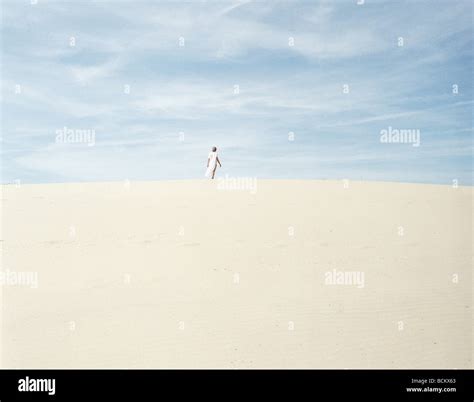 Woman Standing On Sand In Distance Stock Photo Alamy