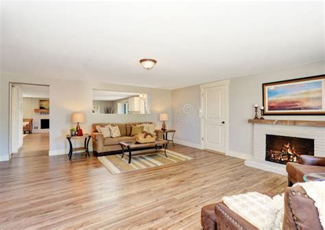 Open Floor Plan Living Room Interior In White Tones With Hardwood Floor