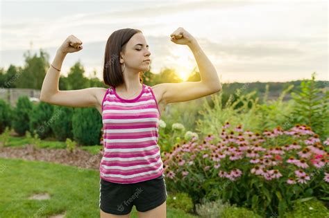 Premium Photo Teenage Girl Flexing Her Muscles