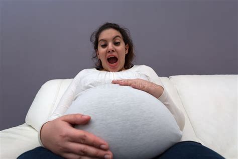 Extreme Angle View Of Pregnant Momâ€ S Giant Baby Bump Stock Photo