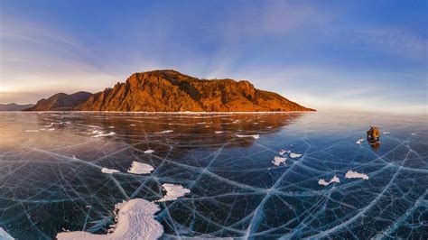 Aerial View Of A Car Crossing Over The Frozen Surface Of Lake Baikal