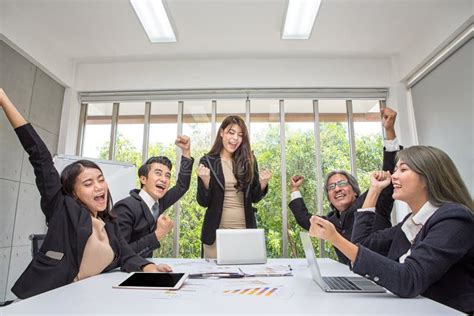 Group Of Happy Business People Cheering In Office Celebrate Success