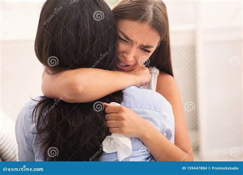 Girl Hugging Crying Friend Comforting Her After Breakup Indoor Stock