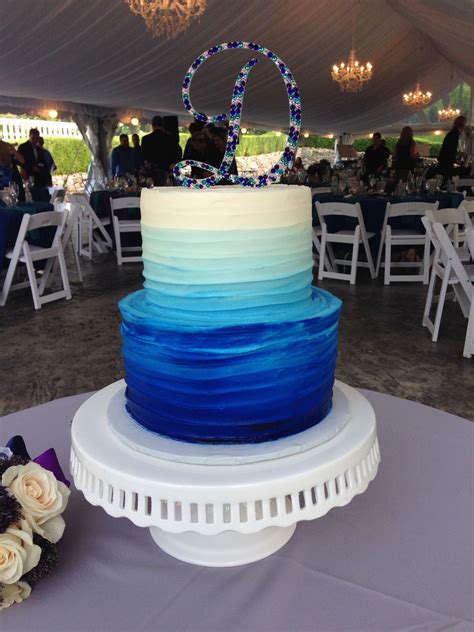 Hand made sugar flowers and french macarons. Textured buttercream wedding cake, 2 tier, blue ombre ...