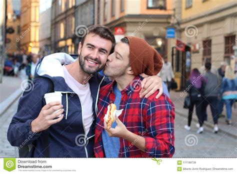 Gay Couple Passionately Kissing On The Street Stock Image