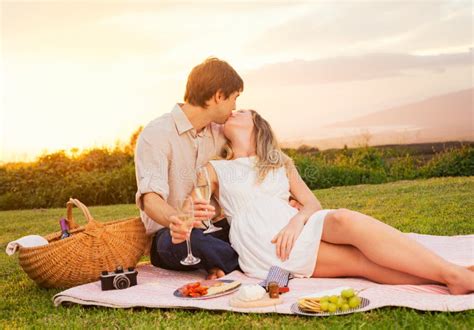Couple Enjoying Romantic Sunset Picnic Stock Photo Image Of Meadow