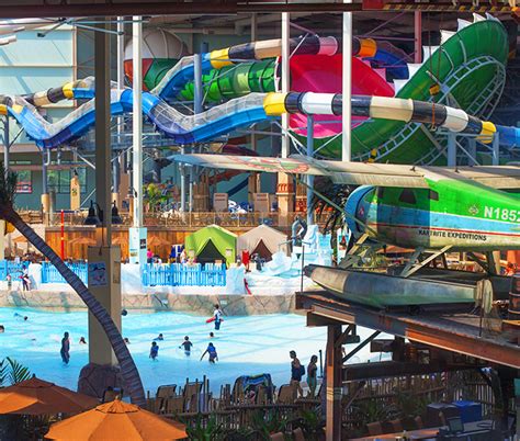 An Indoor Water Park With Slides And Swimming Pools