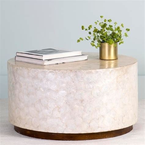 This white coffee table is versatile too, as it can be as a sofa side table, nightstand, tea table, any more. Shop East At Main's Rowden Off-White Wood and Capiz Round ...