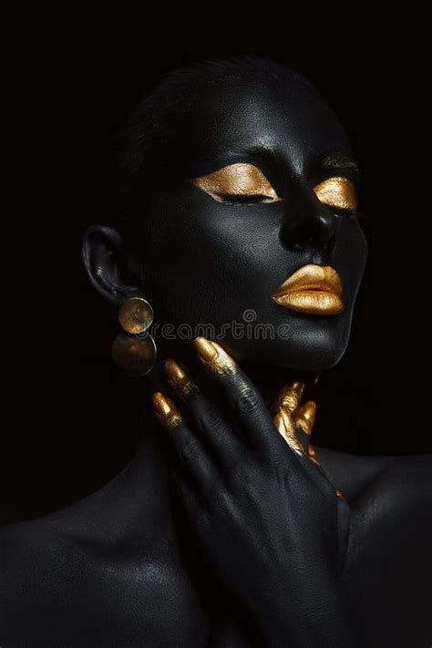 Beauty Woman Painted In Black Skin Color Body Art Gold Makeup Lips Eyelids Fingertips Nails In