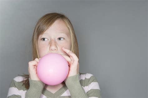 Girl Inflating A Balloon Photograph By Gustoimagesscience Photo Library Pixels