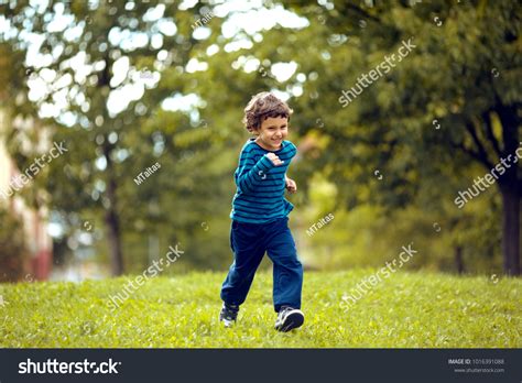 Cute Boy Running Across Grass Und Stock Photo 1016391088 Shutterstock