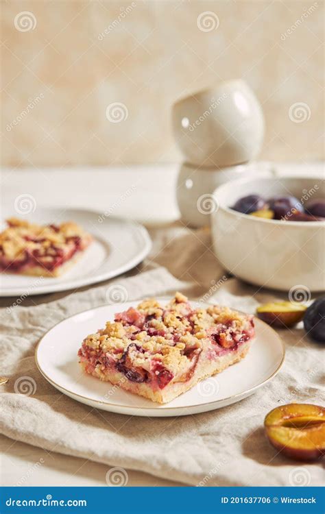 Homemade Plum Cake With Crumbles On Plates On A White Table Stock Photo