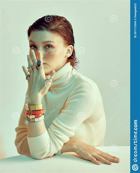 Pretty Girl With Freckles And Stylish Short Haircut Covers Her Face By Hand In Jewelleries