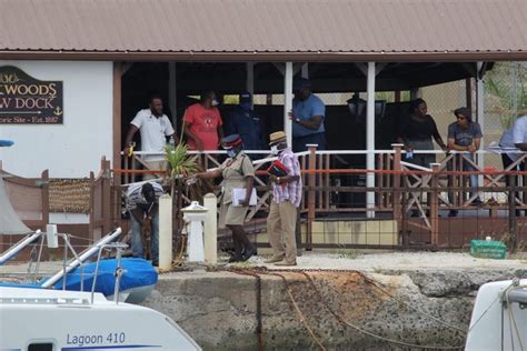 police try to recover body of male and car from careenage barbados today police barbados body
