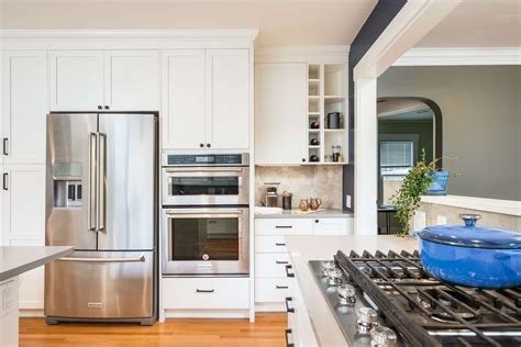 Stainless Steel Appliances Complement White Shaker Cabinets For An