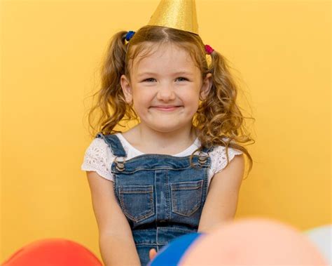 Premium Photo Medium Shot Smiley Girl Wearing Party Hat