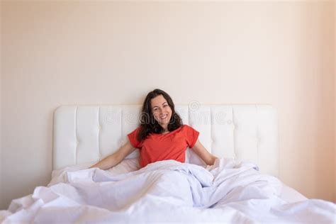 The Girl Sits On The Bed And Stretches The Woman Woke Up Stock Image