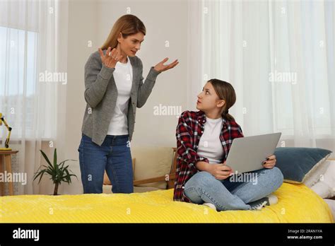 Mother Scolding Her Teenage Daughter At Home Stock Photo Alamy