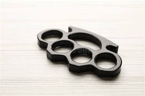 Black Brass Knuckles On Wooden Background Closeup Stock Photo Image