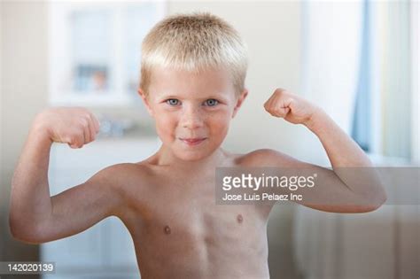 Caucasian Boy Flexing His Muscles Photo Getty Images