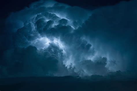 Blue Lightning Strike Surrounded By Storm Clouds Stock Photo Download