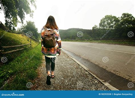 Woman Traveler With Backpack Walking Down The Road In Mountains Travel Concept Space For Text