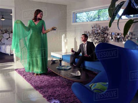 Vintage Inspired Woman Dancing In The Living Room Of Her Mid Century Modern Home With Her