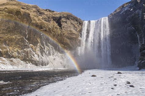 Iceland Skogafoss Waterfall With Rainbow In Winter Stock Photo