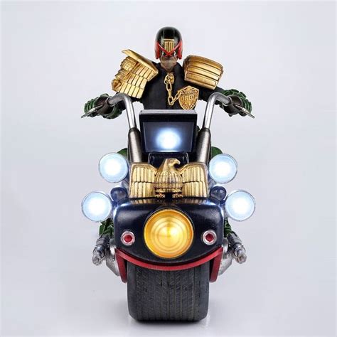 A Man Riding On The Back Of A Motorcycle With An Egyptian Mask On Its Head