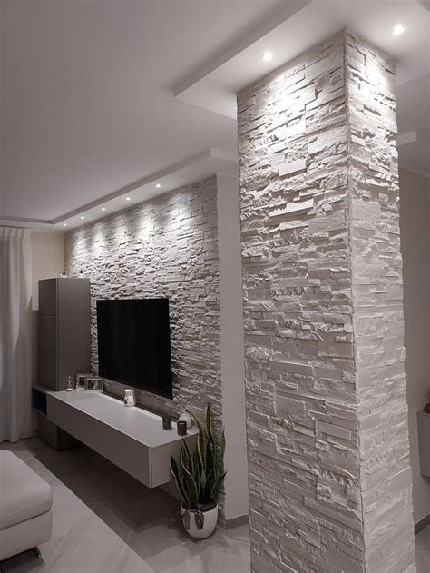 A Modern Living Room With Stone Wall And White Furniture