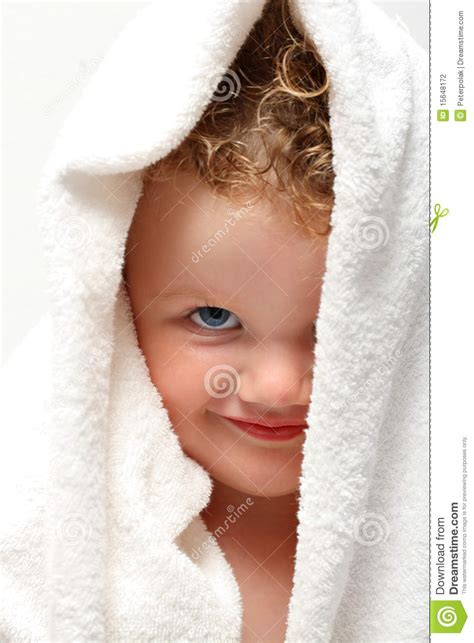 Cute Baby Smiling Under Towel With One Eye Covered Stock Photo Image