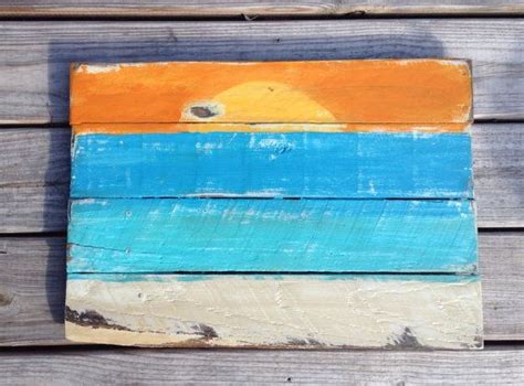 A Wooden Sign With An Orange And Blue Sunset Painted On The Front