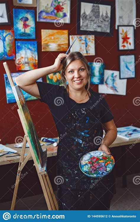 Caucasian Woman Artist Drawing Painting In Art Studio Stock Photo