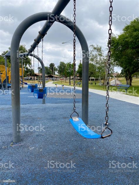 Swings At Children Playground Activities In Public Park Stock Photo