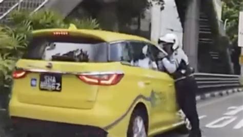 taxi driver 69 arrested for closing window on traffic cop s arm dragging him along the road