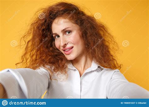 Close Up Of Smiling Young Redhead Woman Girl In White Shirt Posing Isolated On Yellow Orange