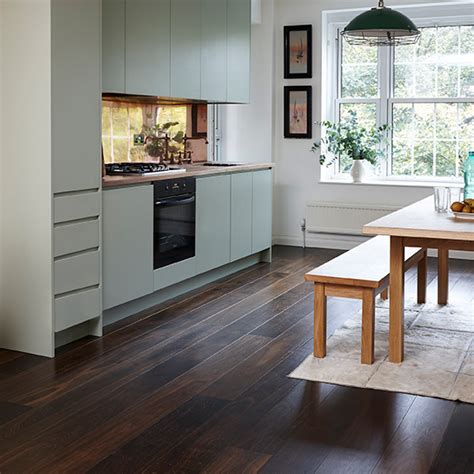 Get some inspiration from these beautiful kitchen designs all featuring dark wood in either the flooring or cabinets or both. Wood flooring | Ideal Home