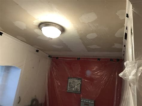 Process of removing the top surface of a material, such as wood, using sandpaper. How to Remove Popcorn Ceiling - thisaveragemom