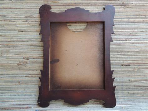 An Old Wooden Frame Sitting On Top Of A Table