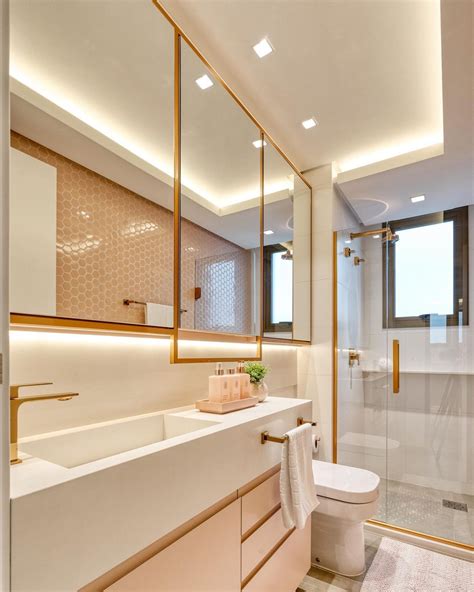 Banheiro contemporâneo branco e rosa com metais dourados e revestimento hexágono Decor Salteado
