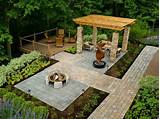 Irregular shaped flagstone pavers with beige tones hug a bank of water on the side of the patio. Paver Patio Ideas - Landscaping Network